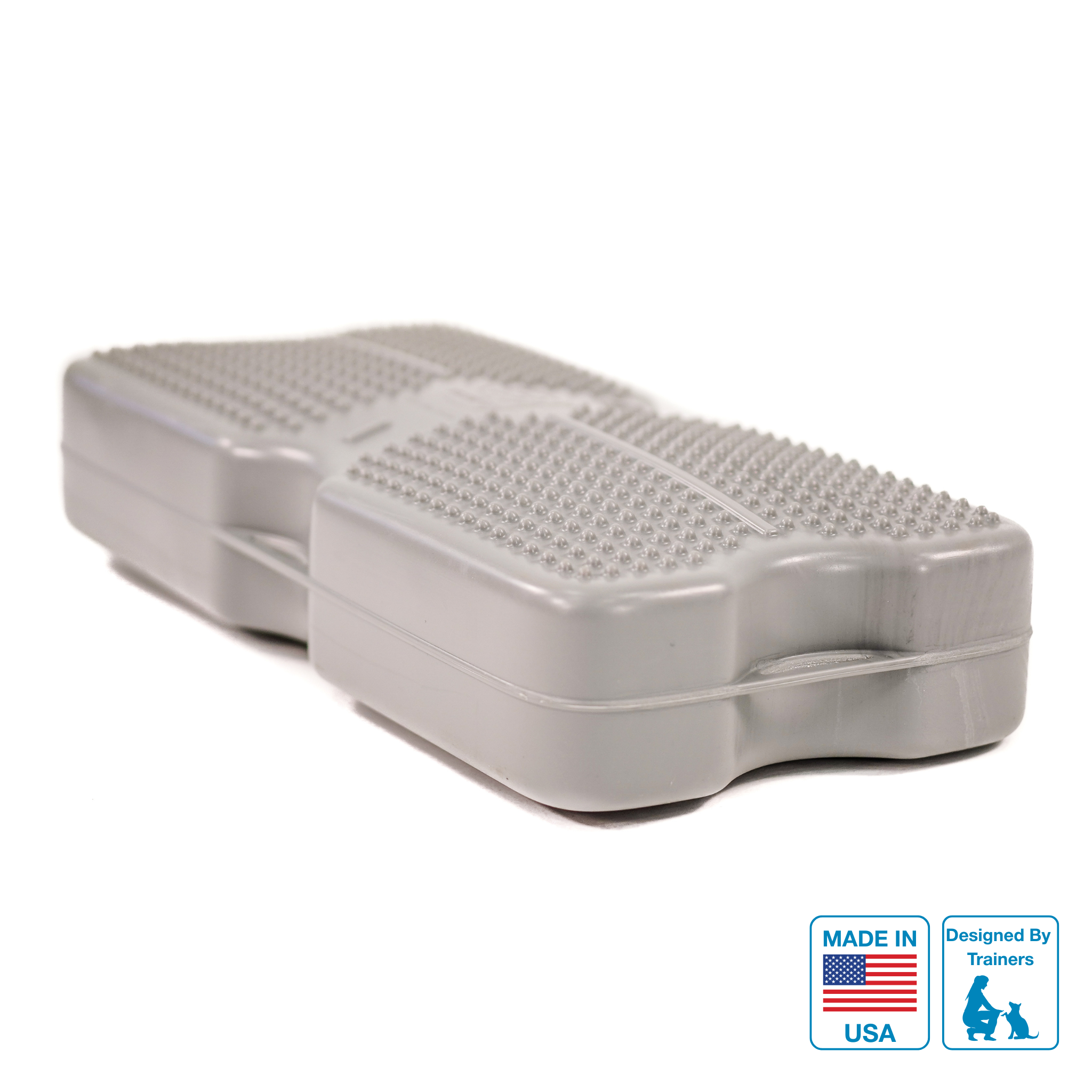 A grey Propel Air inflatable dog training platform with texture for grip, featuring connection points and a label indicating it is made in the USA.