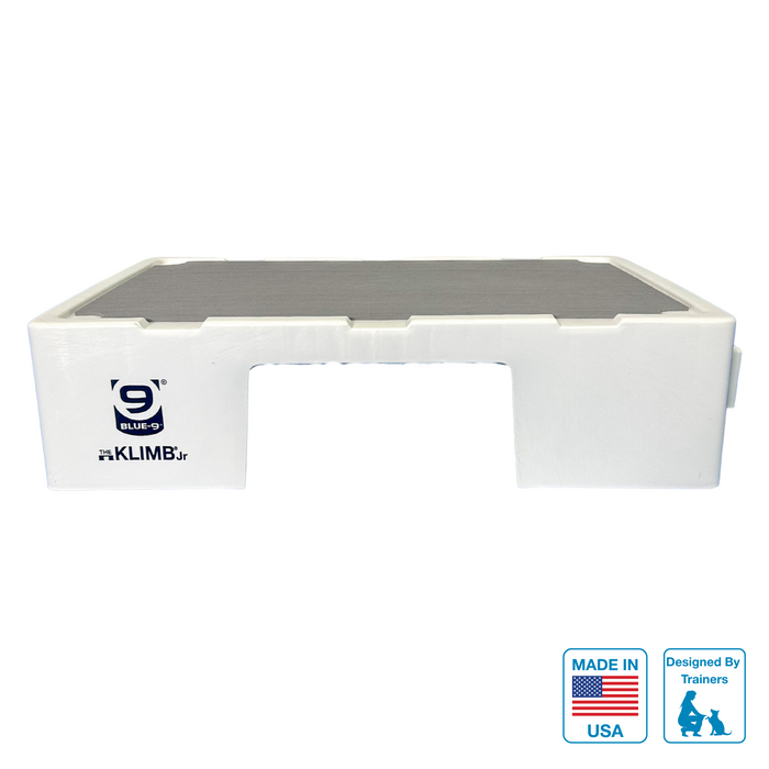 White KLIMB Jr with a grey non-slip surface on a white background with a black KLIMB Jr logo. Made in USA Badge and Designed by trainers badge on lower right corner.