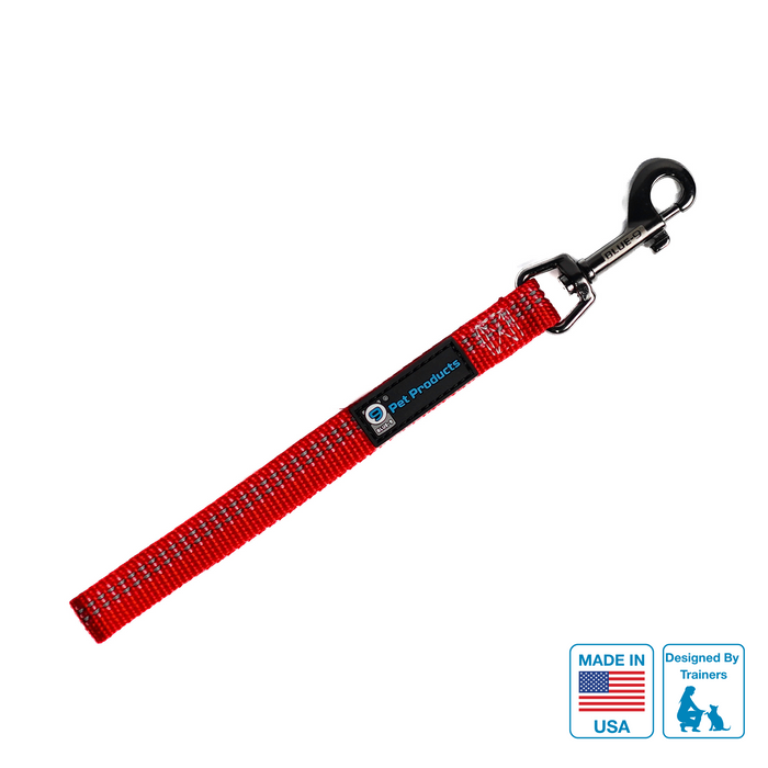 A red and reflective dog training tab leash with a metal clasp, labeled with 'MADE IN USA'.