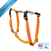 Orange dog harness with metal d-ring on a white background, featuring 'Made in USA' and 'Designed by Trainers' logos.