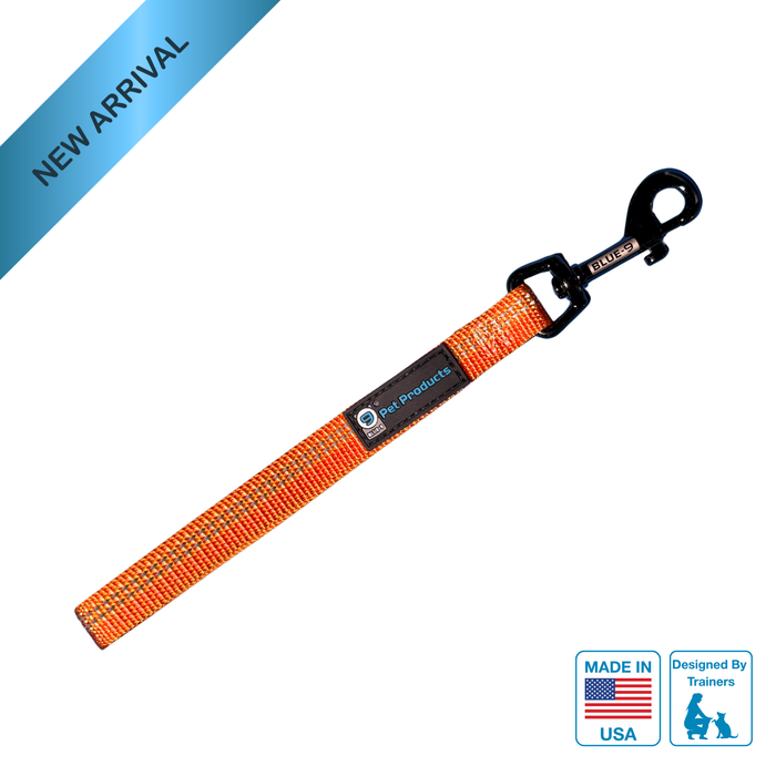 Reflective Orange dog tab leash with black clip on a white background, featuring 'Made in USA' and 'Designed by Trainers' logos.