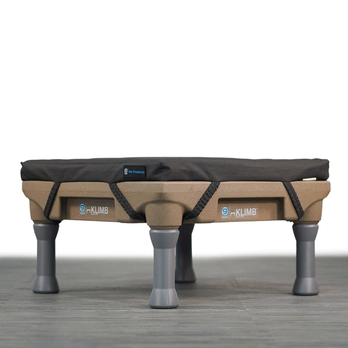 Grey Restore dog bed on a tan KLIMB dog training platform